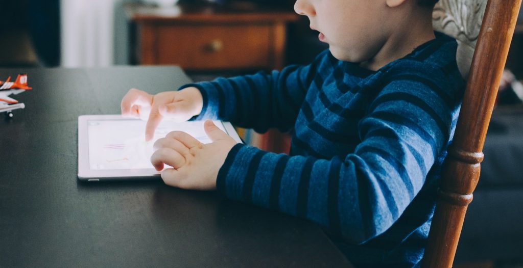 Child playing on tablet.